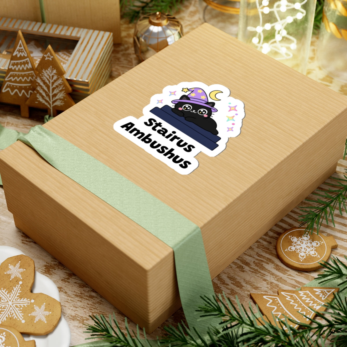 Stairus Ambushus wizard cat sticker on a kraft gift box with a green ribbon and holiday cookies