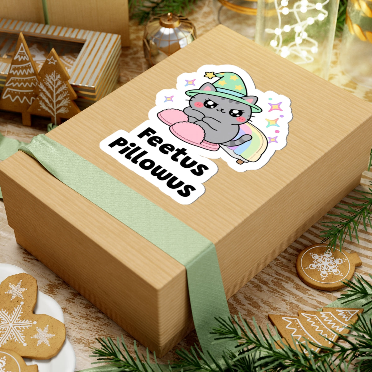 Feetus Pillowus wizard cat sticker on a kraft gift box with a green ribbon and holiday cookies