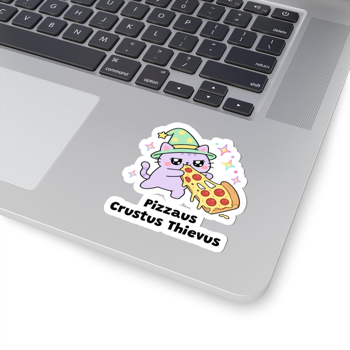 Pizzaus Crustus Thievus wizard cat sticker stuck on a silver laptop next to the keyboard