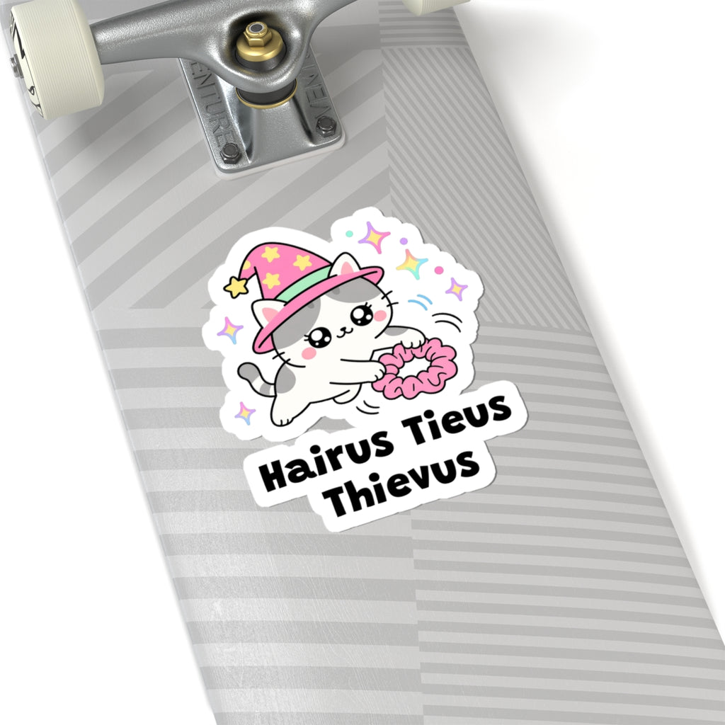 Hairus Tieus Thievus wizard cat sticker on a grey skateboard deck near the truck