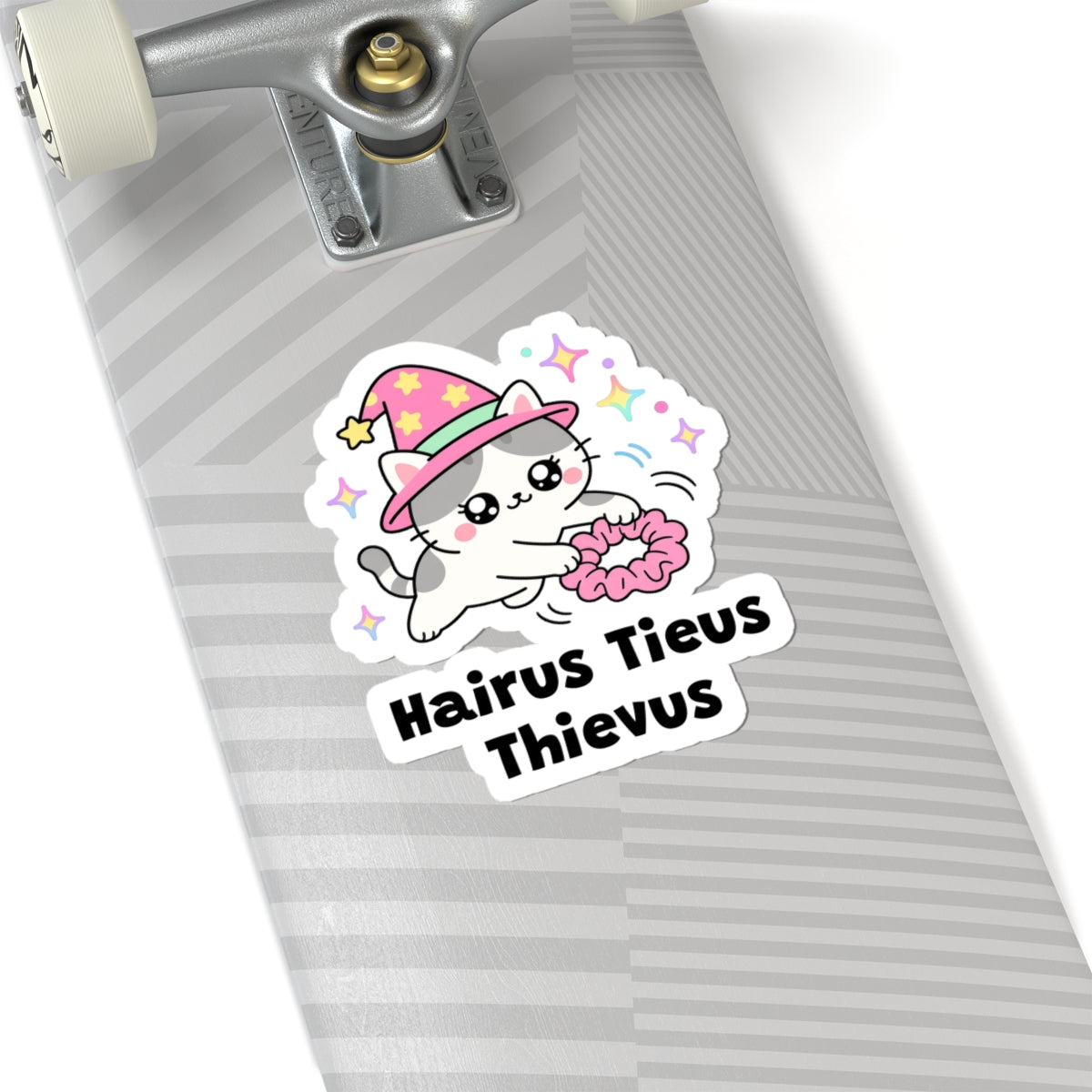 Hairus Tieus Thievus wizard cat sticker on a grey skateboard deck near the truck
