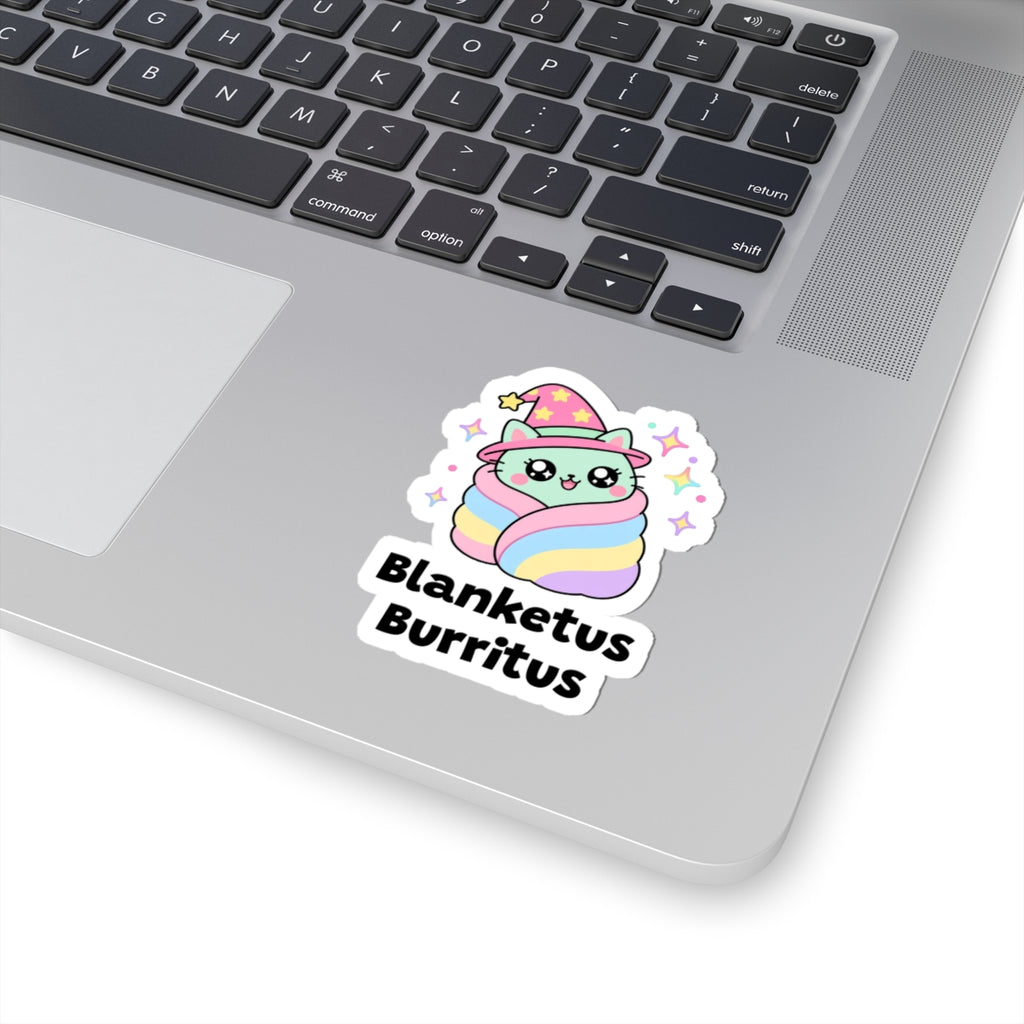 Blanketus Burritus wizard cat sticker stuck on a silver laptop next to the keyboard