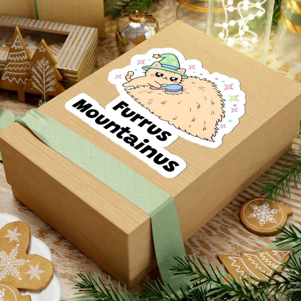 Furrus Mountainus wizard cat sticker on a kraft gift box with a green ribbon and holiday cookies