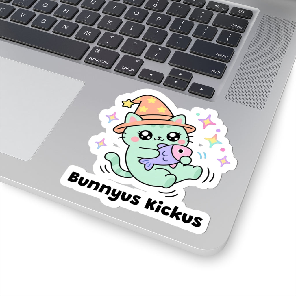 Bunnyus Kickus wizard cat sticker stuck on a silver laptop next to the keyboard