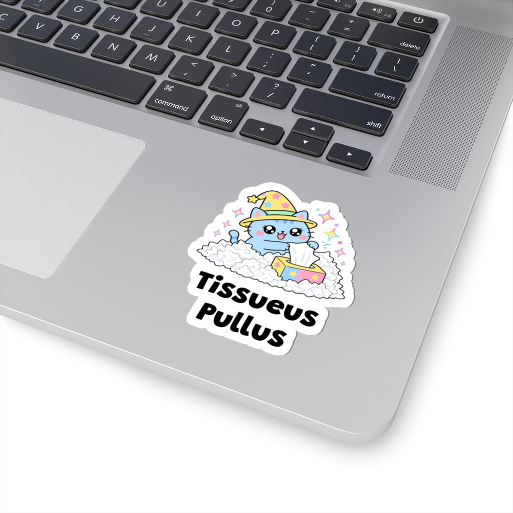 Tissueus Pullus wizard cat sticker stuck on a silver laptop next to the keyboard