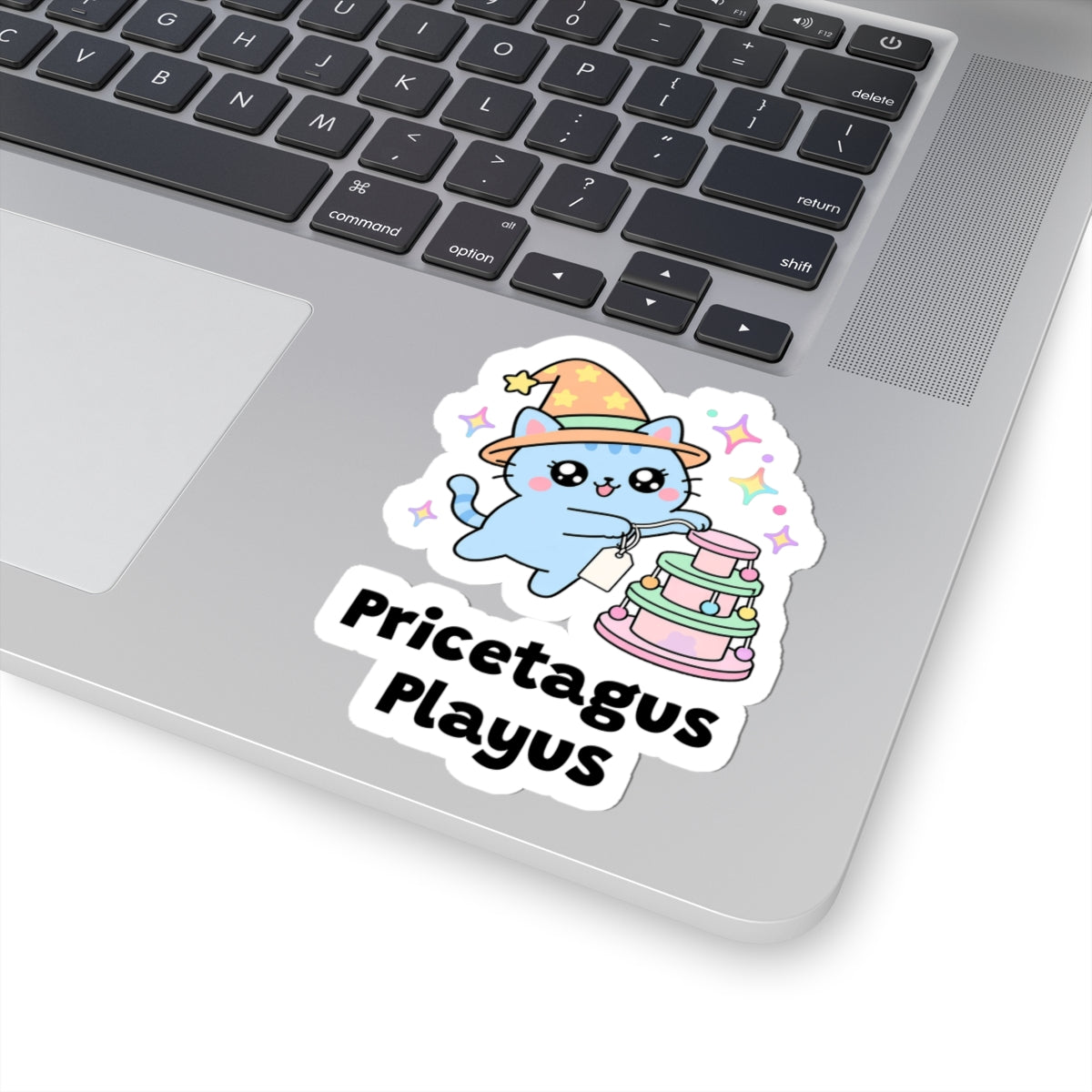 Pricetagus Playus wizard cat sticker stuck on a silver laptop next to the keyboard