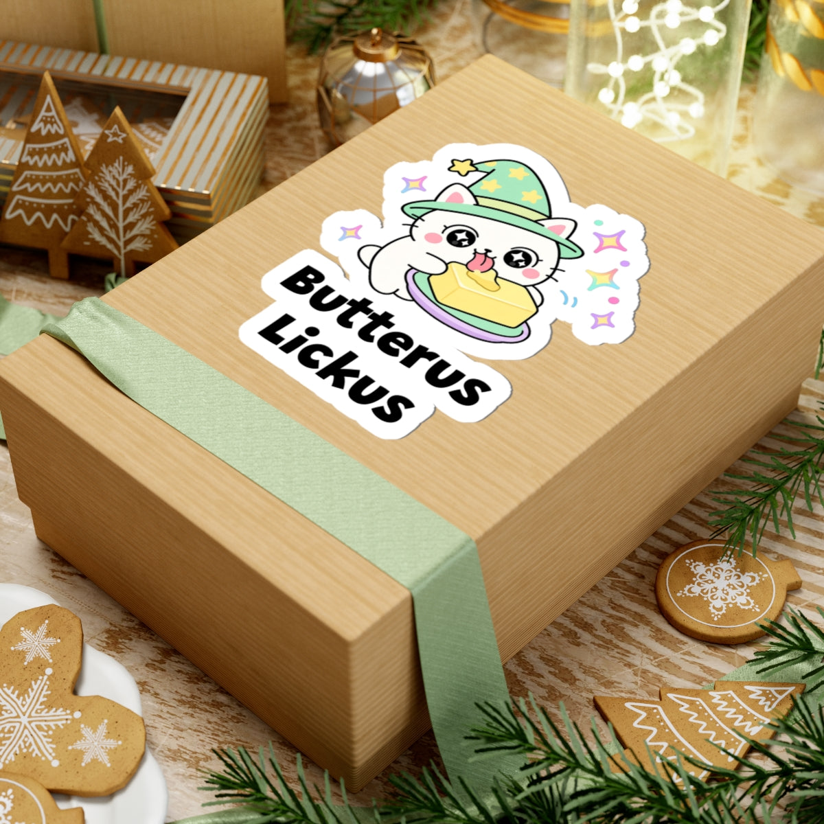 Butterus Lickus wizard cat sticker on a kraft gift box with a green ribbon and holiday cookies