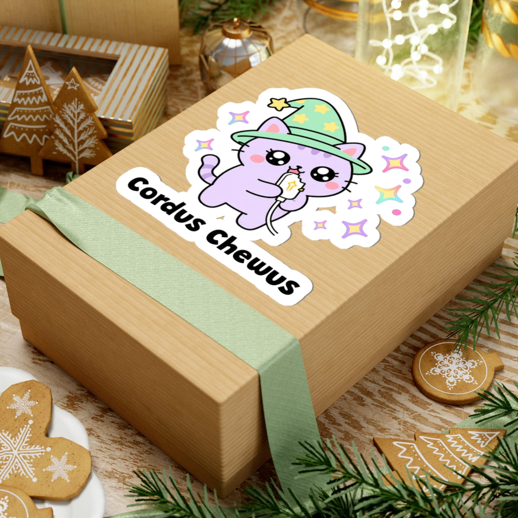 Cordus Chewus wizard cat sticker on a kraft gift box with a green ribbon and holiday cookies