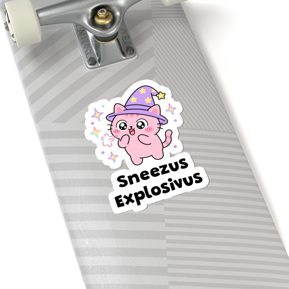 Sneezus Explosivus wizard cat sticker on a grey skateboard deck near the truck