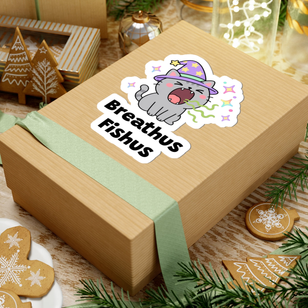 Breathus Fishus wizard cat sticker on a kraft gift box with a green ribbon and holiday cookies
