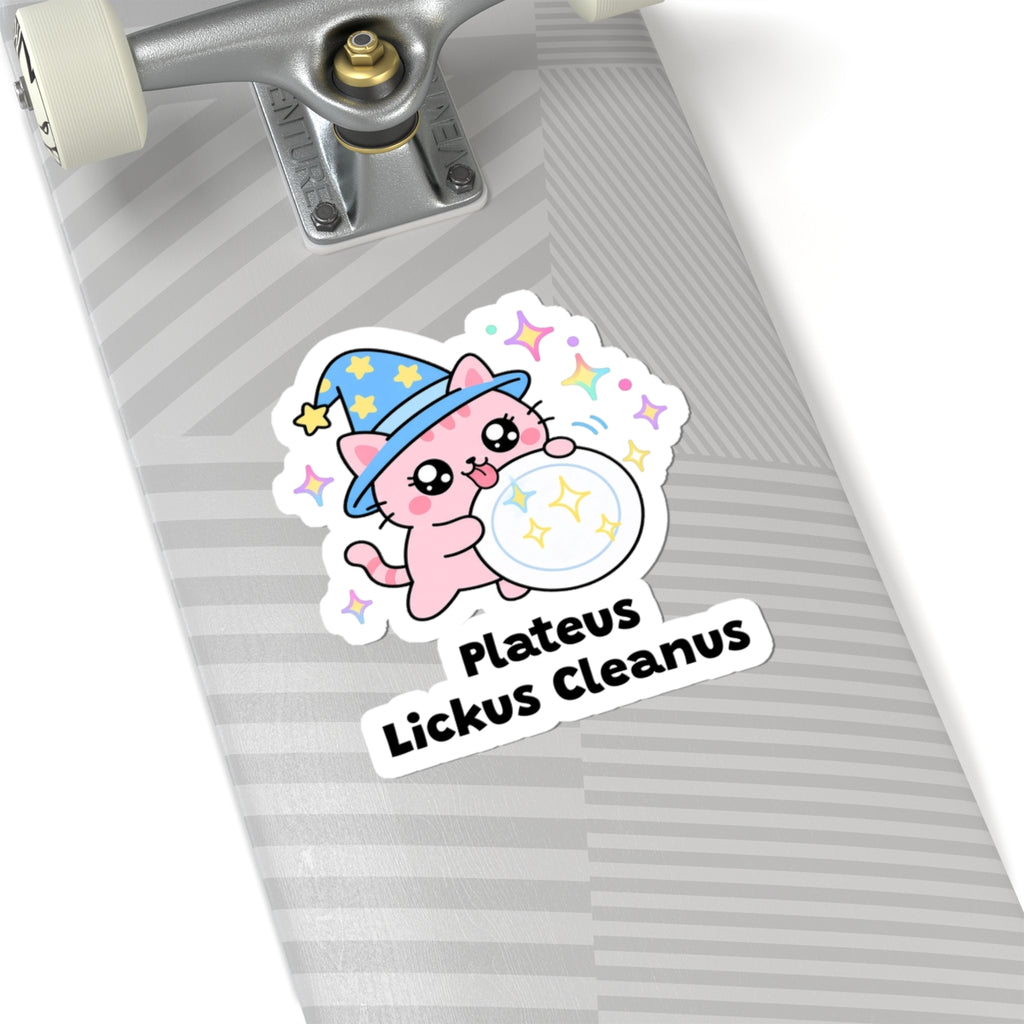 Plateus Lickus Cleanus wizard cat sticker on a grey skateboard deck near the truck