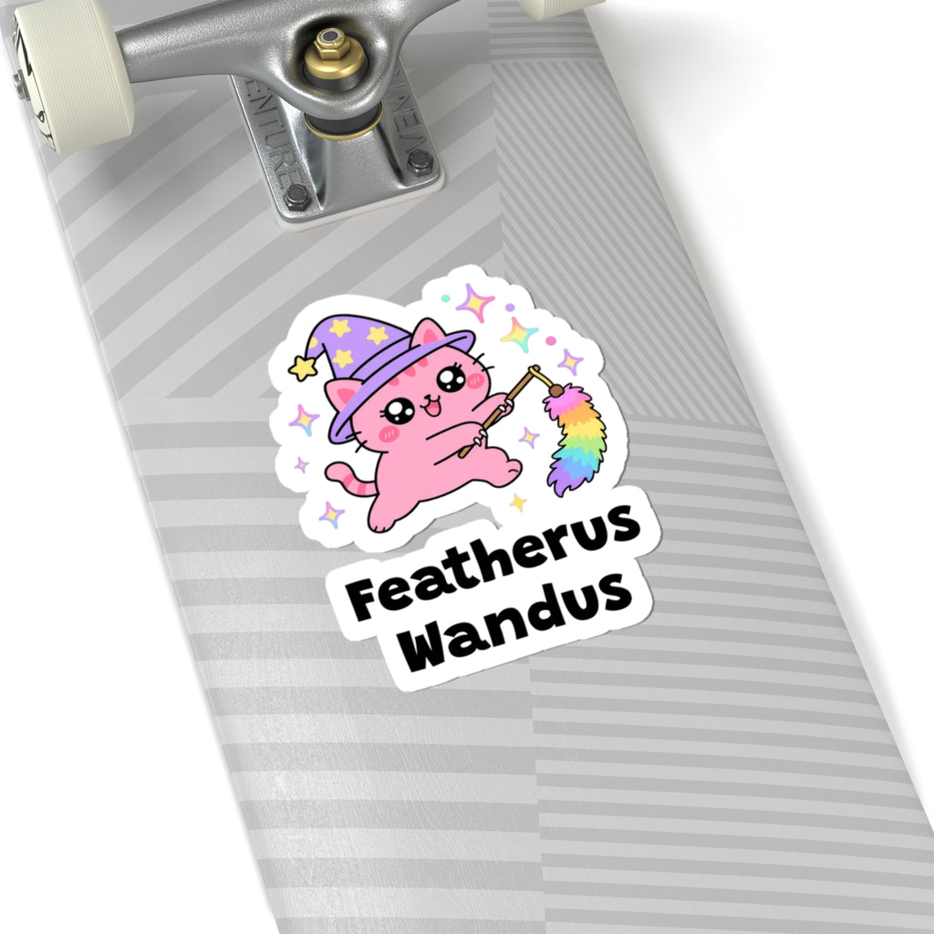 Featherus Wandus wizard cat sticker on a grey skateboard deck near the truck