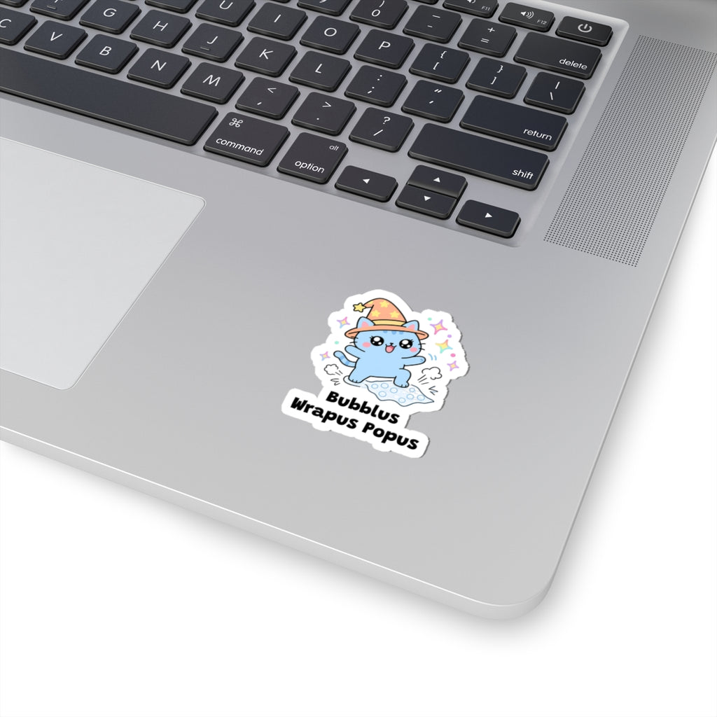 Bubblus Wrapus Popus wizard cat sticker stuck on a silver laptop next to the keyboard