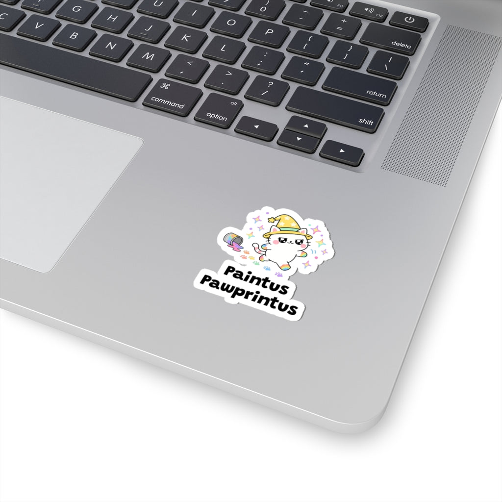 Paintus Pawprintus wizard cat sticker stuck on a silver laptop next to the keyboard
