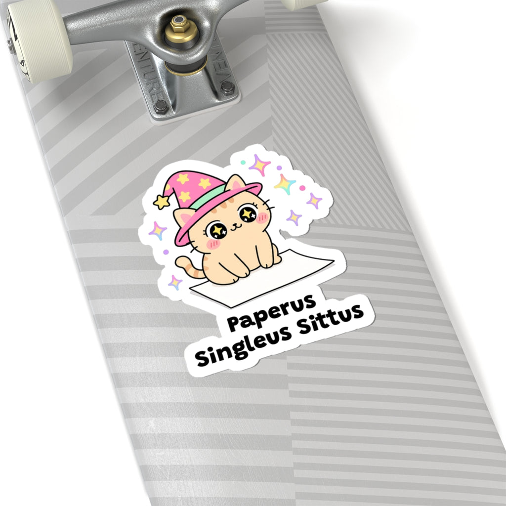 Paperus Singleus Sittus wizard cat sticker on a grey skateboard deck near the truck