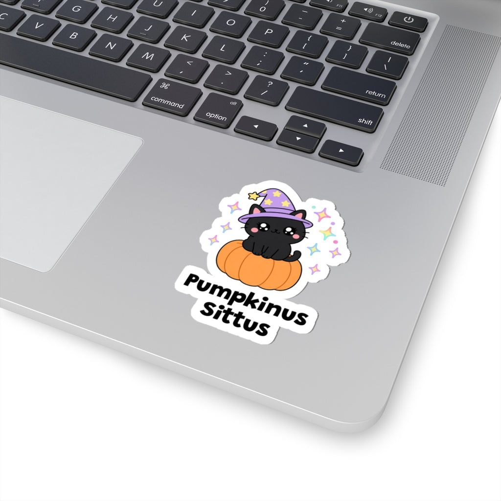 Pumpkinus Sittus wizard cat sticker stuck on a silver laptop next to the keyboard