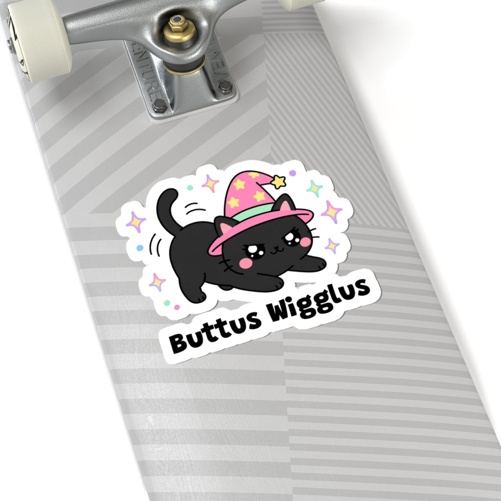 Buttus Wigglus wizard cat sticker on a grey skateboard deck near the truck