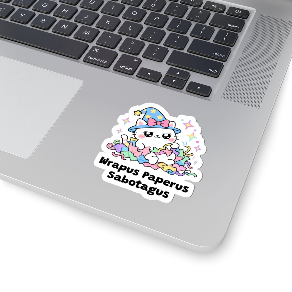 Wrapus Paperus Sabotagus wizard cat sticker stuck on a silver laptop next to the keyboard