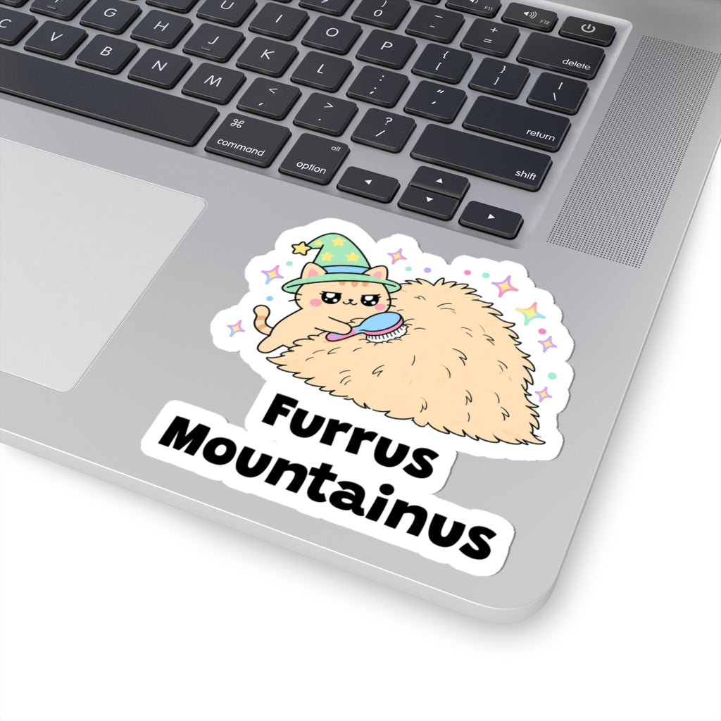 Furrus Mountainus wizard cat sticker stuck on a silver laptop next to the keyboard