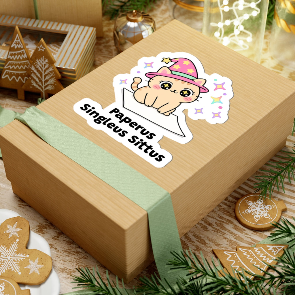 Paperus Singleus Sittus wizard cat sticker on a kraft gift box with a green ribbon and holiday cookies