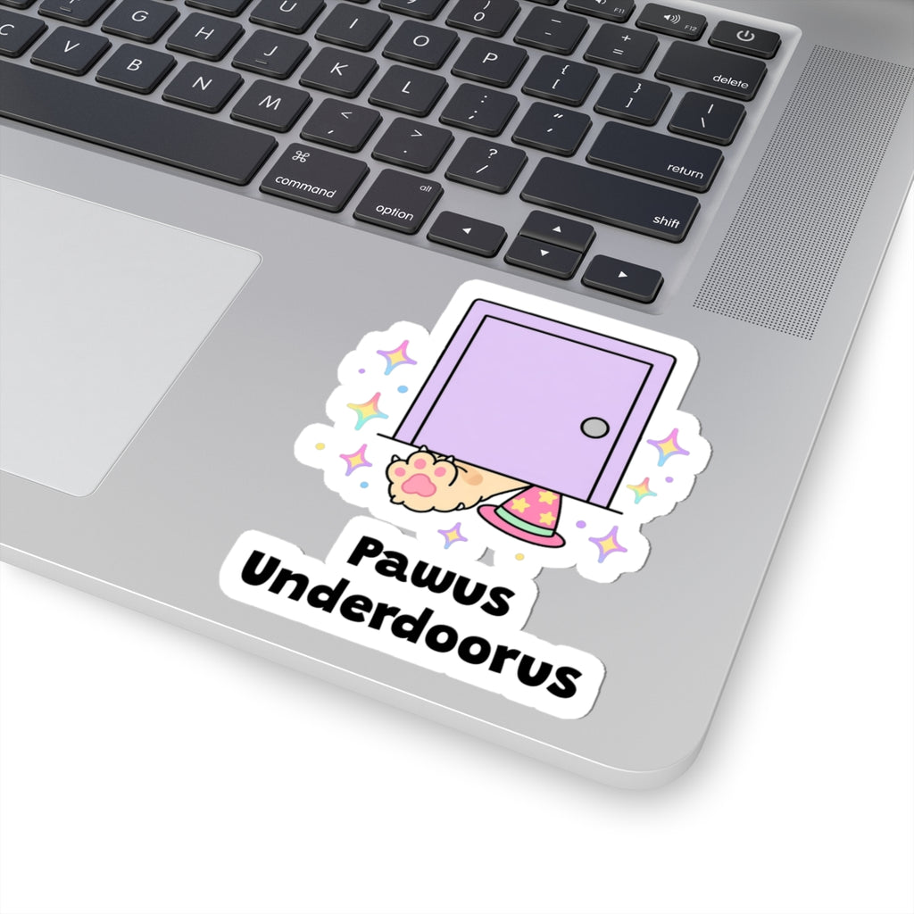 Pawus Underdoorus wizard cat sticker stuck on a silver laptop next to the keyboard