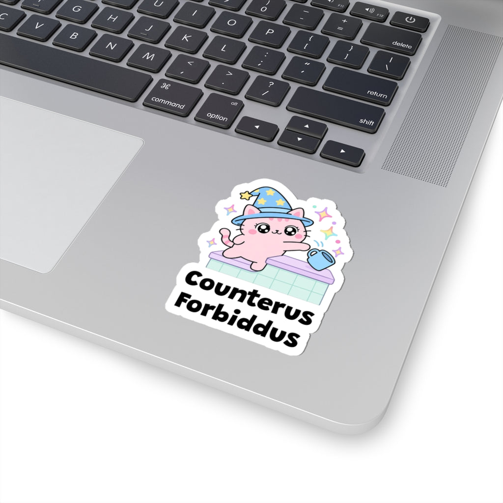 Counterus Forbiddus wizard cat sticker stuck on a silver laptop next to the keyboard