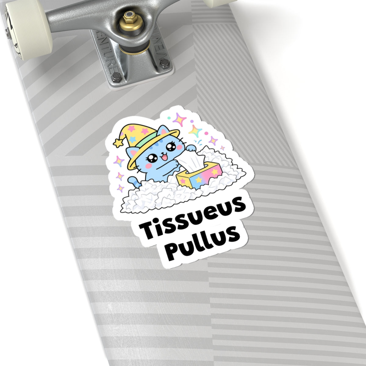 Tissueus Pullus wizard cat sticker on a grey skateboard deck near the truck
