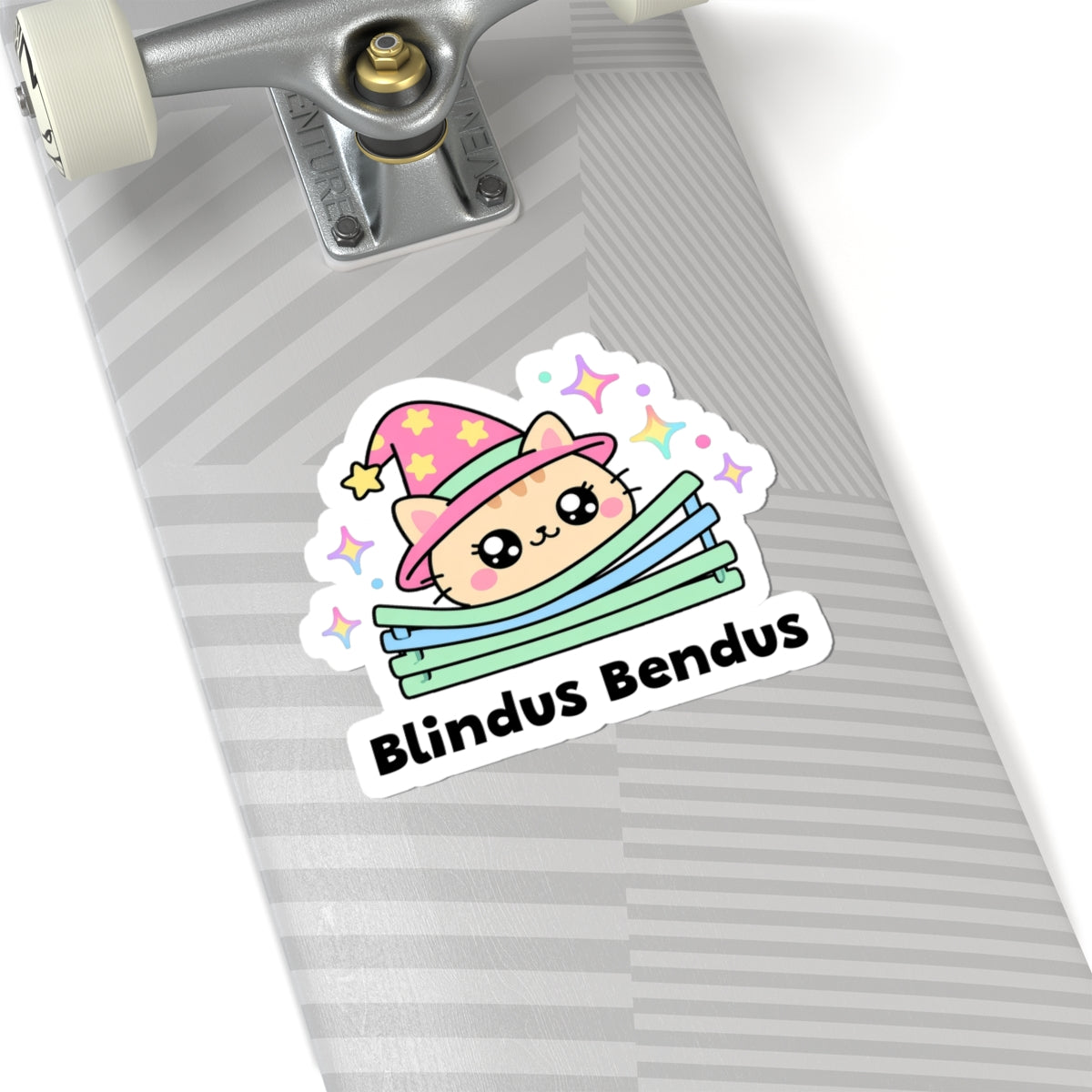 Blindus Bendus wizard cat sticker on a grey skateboard deck near the truck