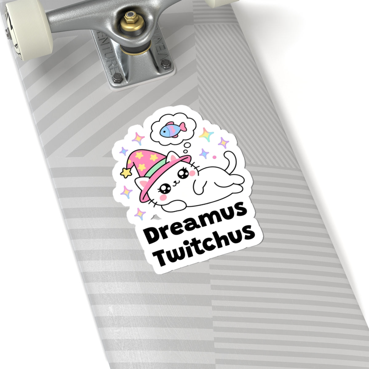 Dreamus Twitchus wizard cat sticker on a grey skateboard deck near the truck