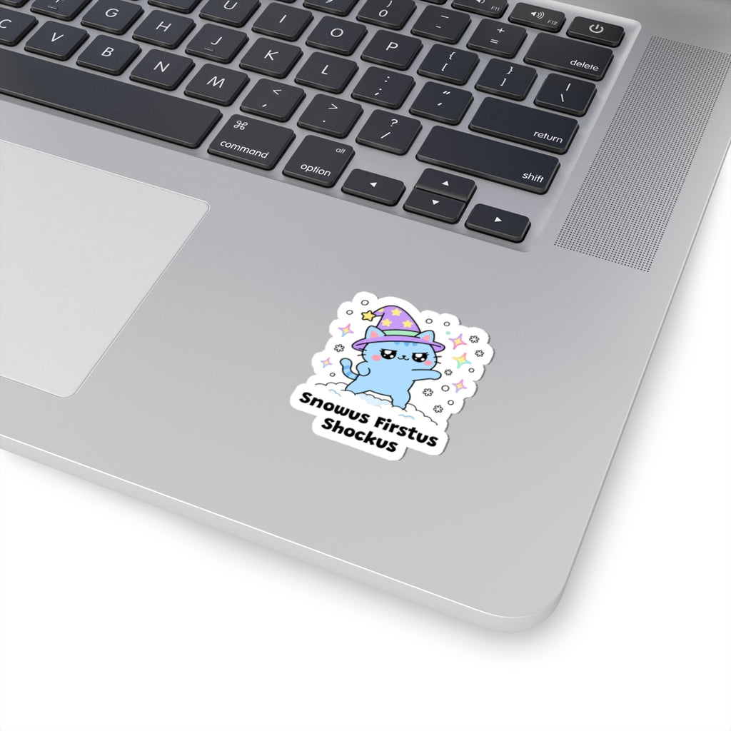 Snowus Firstus Shockus wizard cat sticker stuck on a silver laptop next to the keyboard