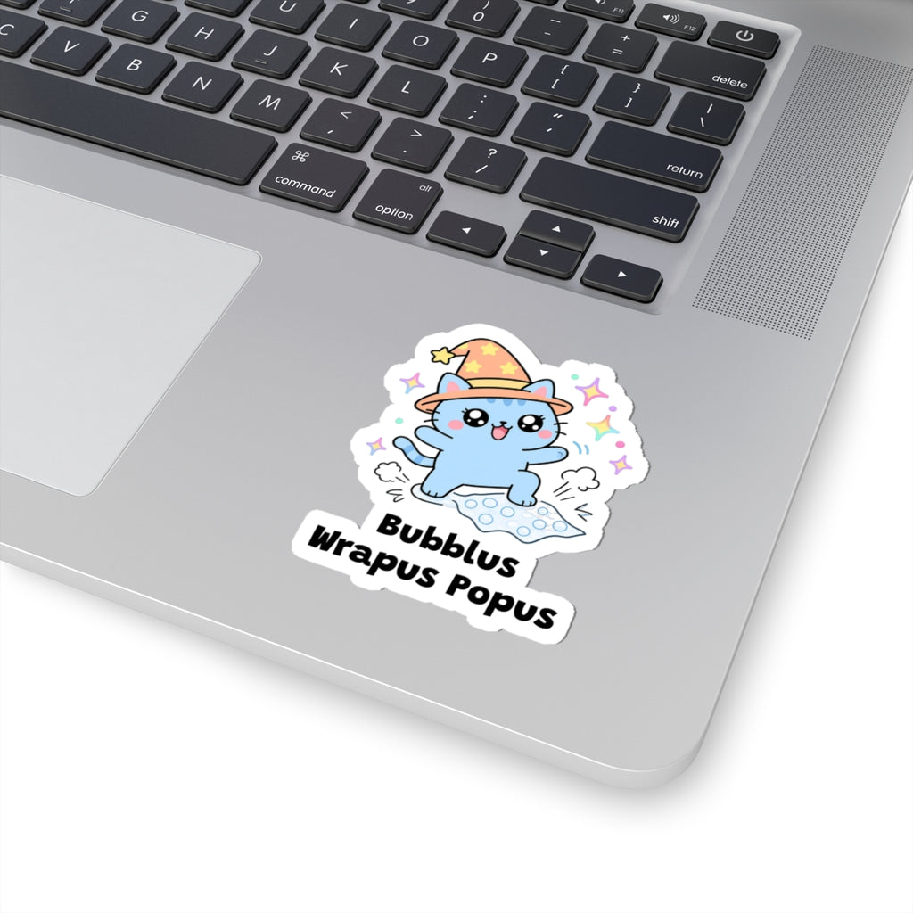 Bubblus Wrapus Popus wizard cat sticker stuck on a silver laptop next to the keyboard