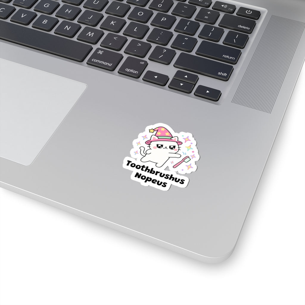 Toothbrushus Nopeus wizard cat sticker stuck on a silver laptop next to the keyboard