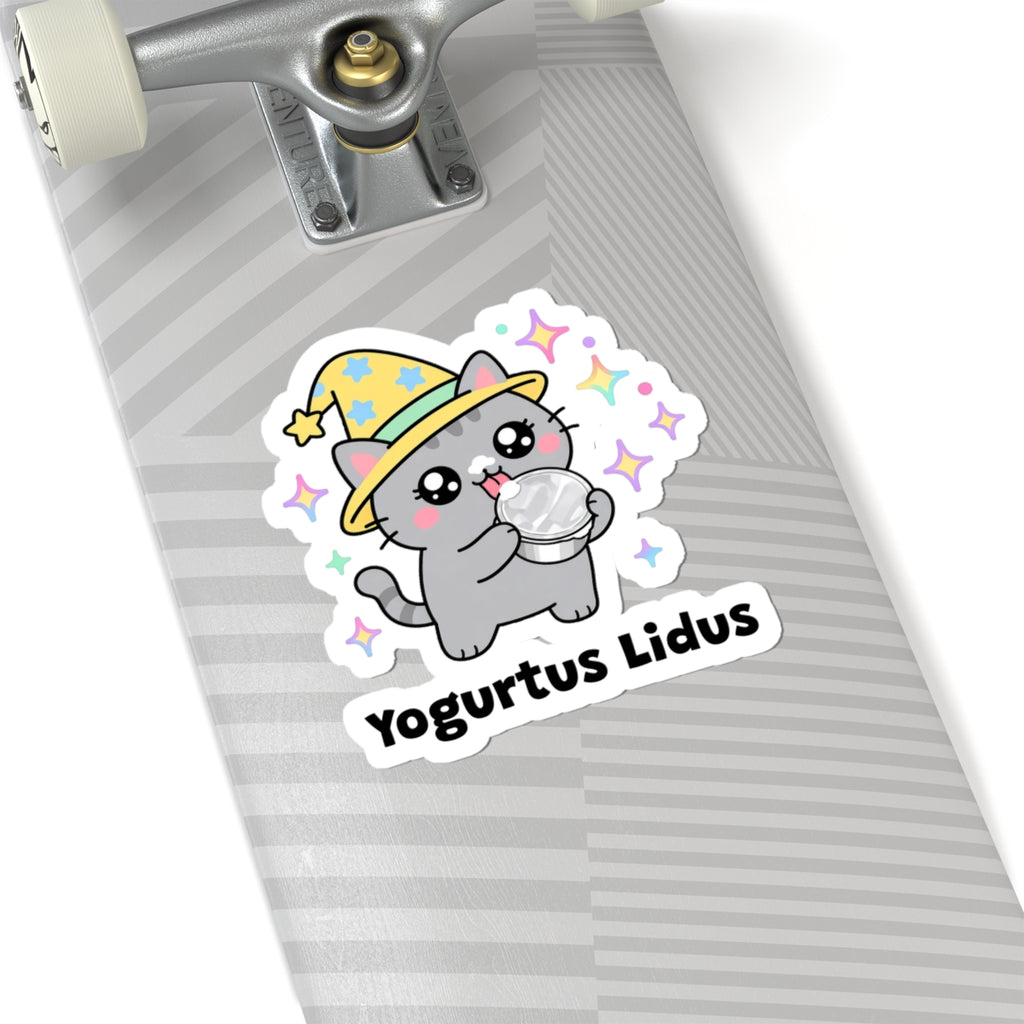 Yogurtus Lidus wizard cat sticker on a grey skateboard deck near the truck