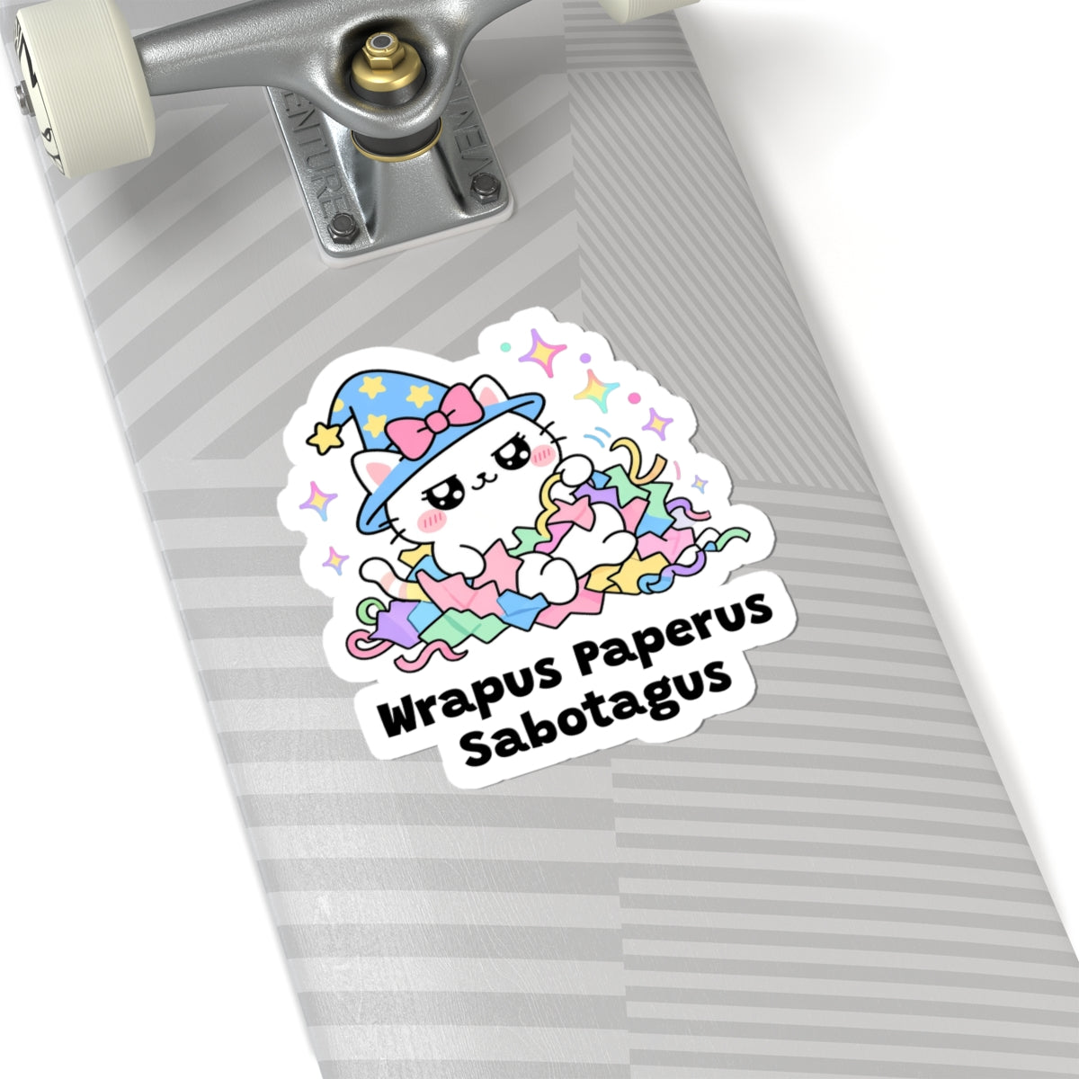 Wrapus Paperus Sabotagus wizard cat sticker on a grey skateboard deck near the truck