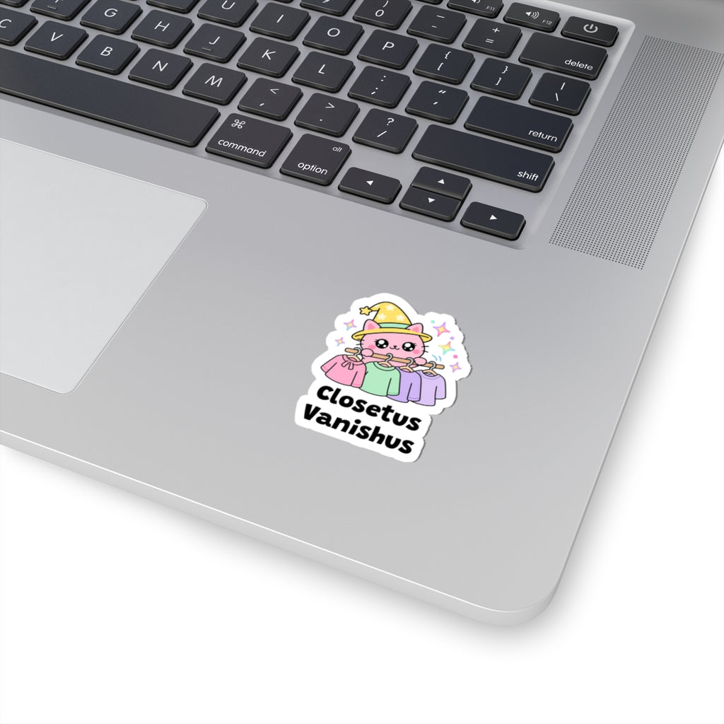 Closetus Vanishus wizard cat sticker stuck on a silver laptop next to the keyboard