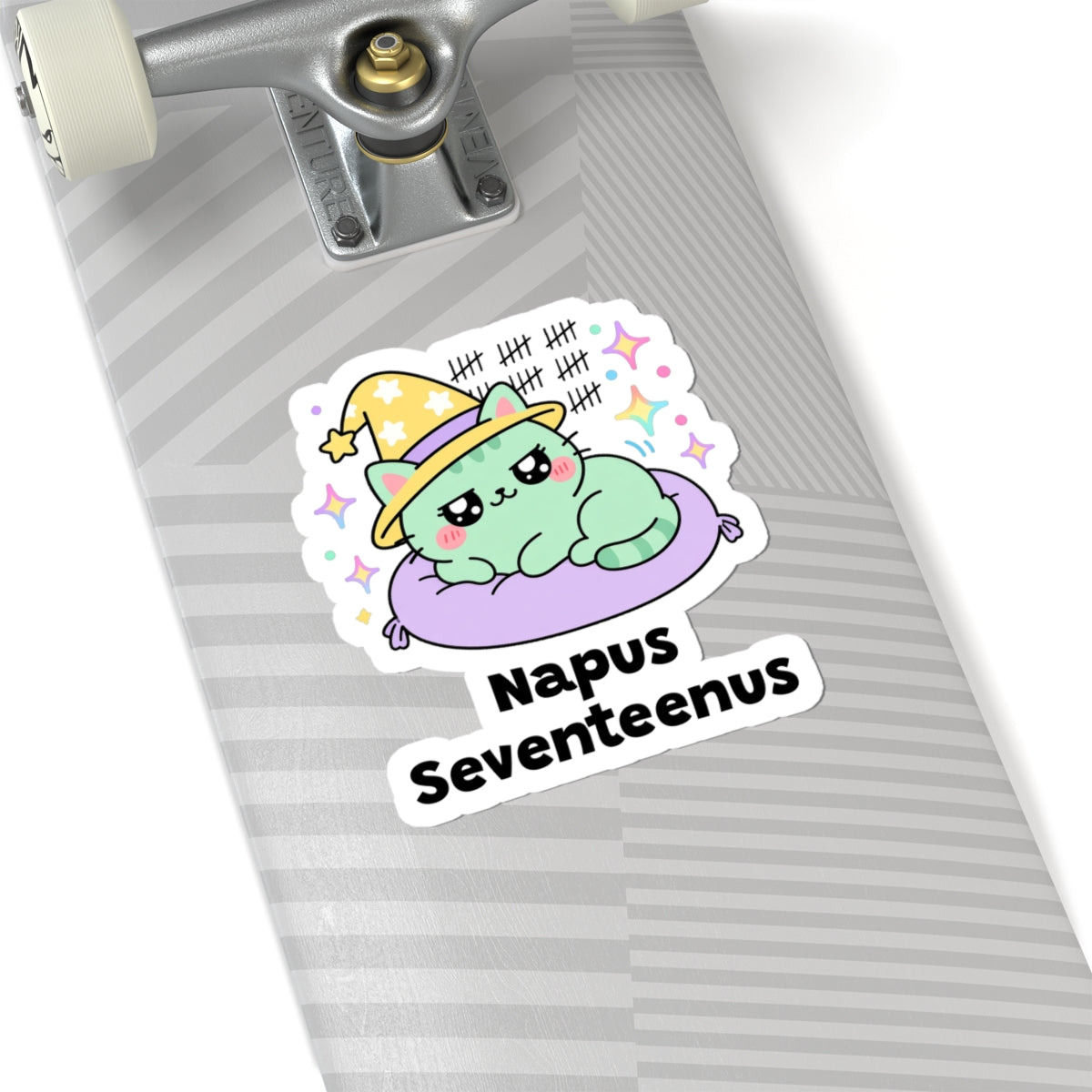 Napus Seventeenus wizard cat sticker on a grey skateboard deck near the truck