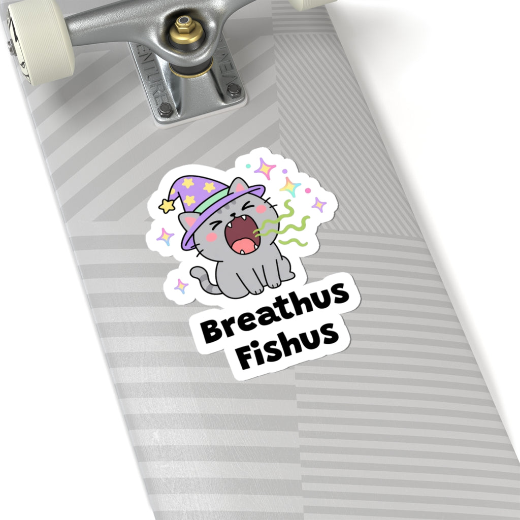 Breathus Fishus wizard cat sticker on a grey skateboard deck near the truck