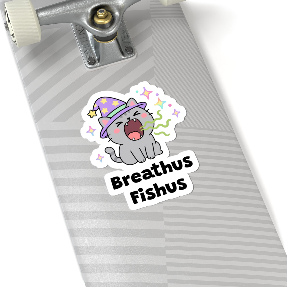 Breathus Fishus wizard cat sticker on a grey skateboard deck near the truck