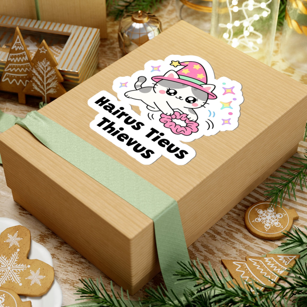 Hairus Tieus Thievus wizard cat sticker on a kraft gift box with a green ribbon and holiday cookies
