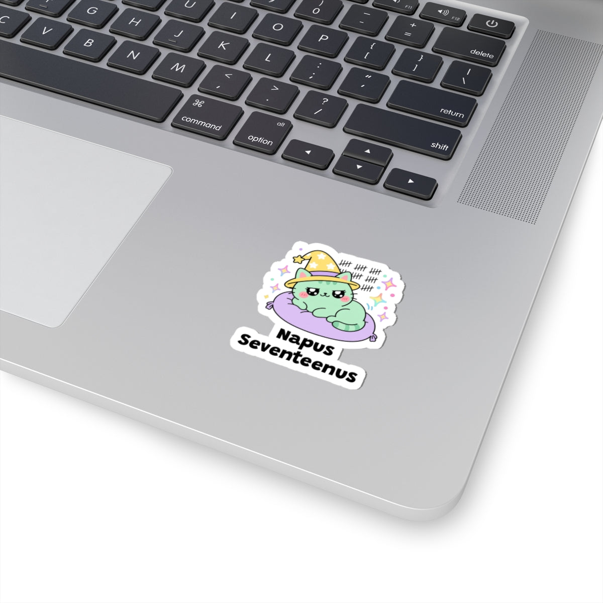 Napus Seventeenus wizard cat sticker stuck on a silver laptop next to the keyboard