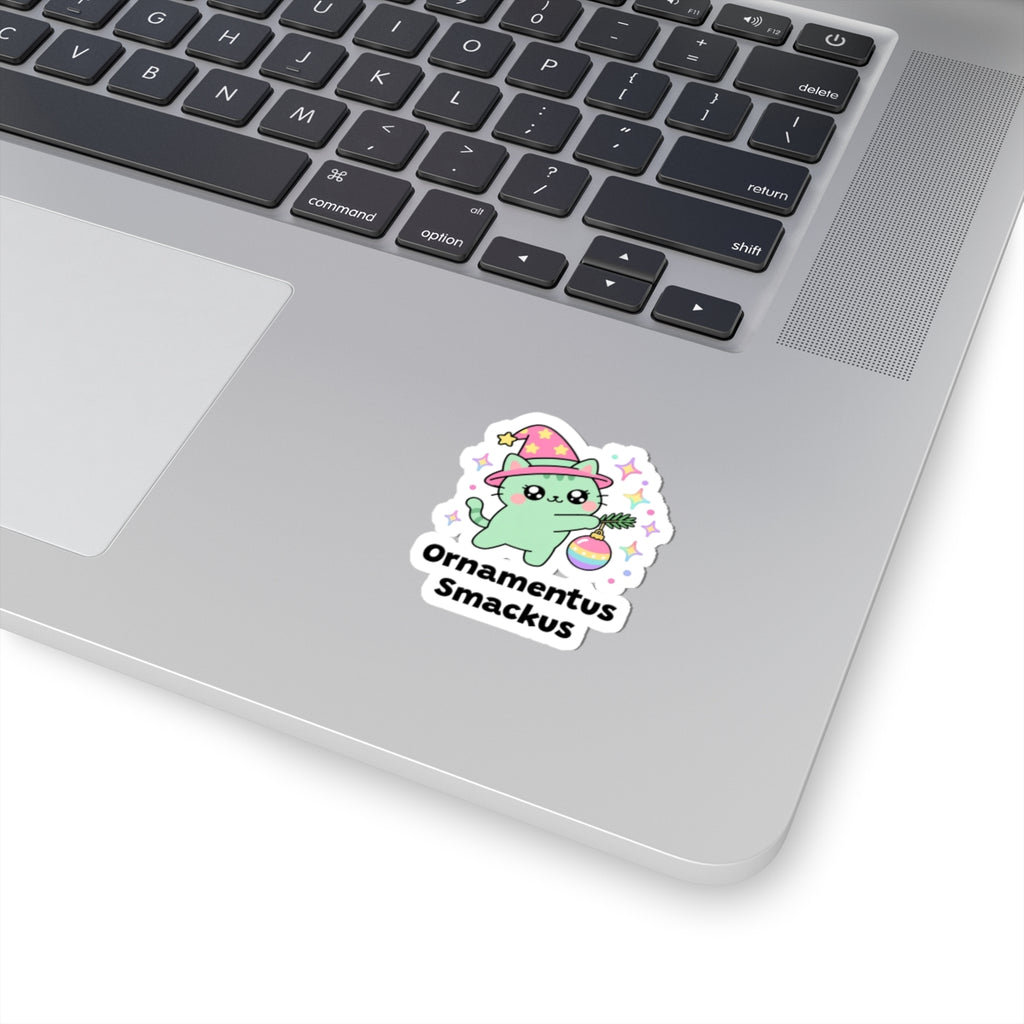 Ornamentus Smackus wizard cat sticker stuck on a silver laptop next to the keyboard