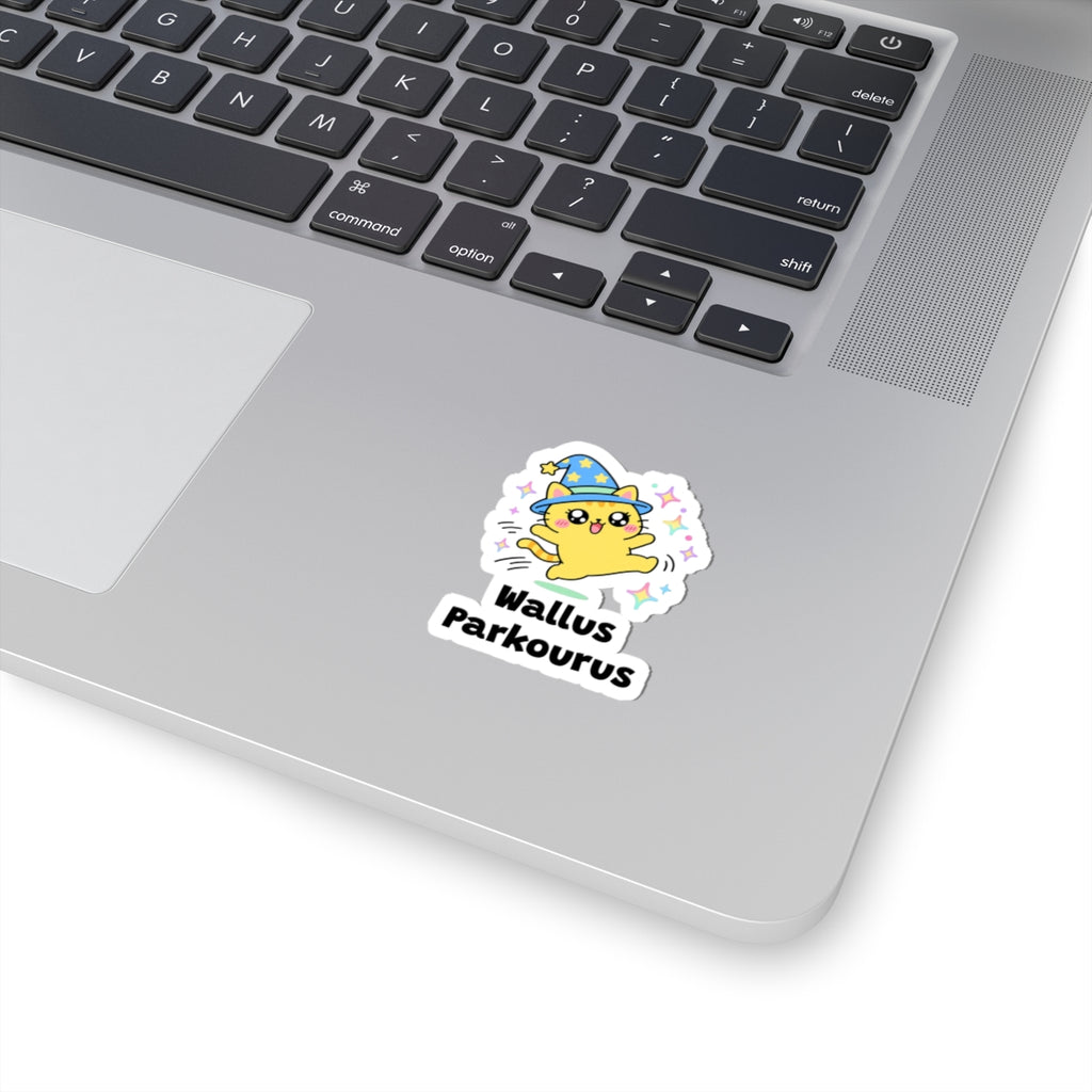 Wallus Parkourus wizard cat sticker stuck on a silver laptop next to the keyboard