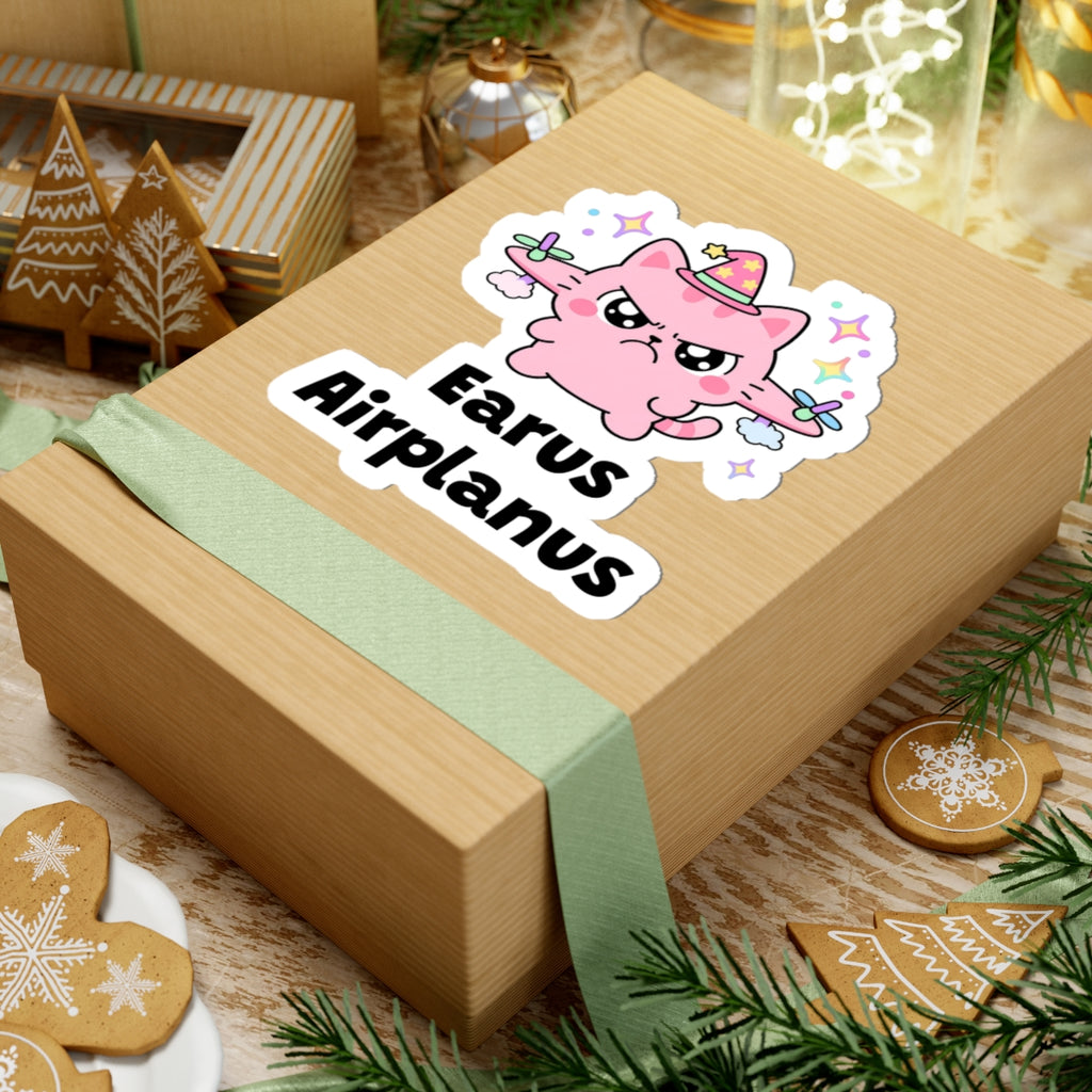 Earus Airplanus wizard cat sticker on a kraft gift box with a green ribbon and holiday cookies
