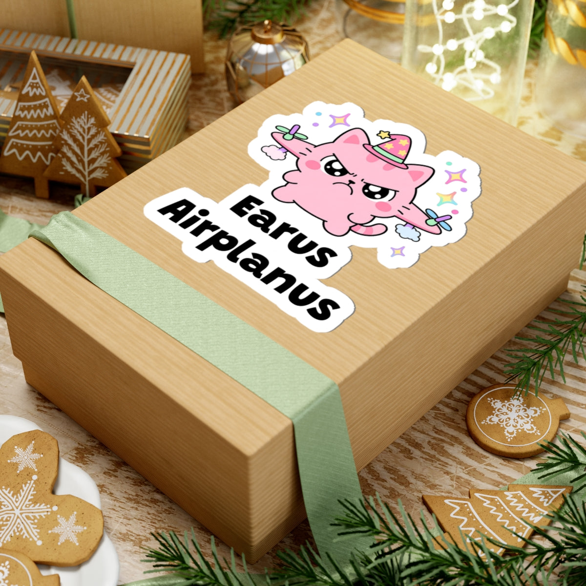 Earus Airplanus wizard cat sticker on a kraft gift box with a green ribbon and holiday cookies