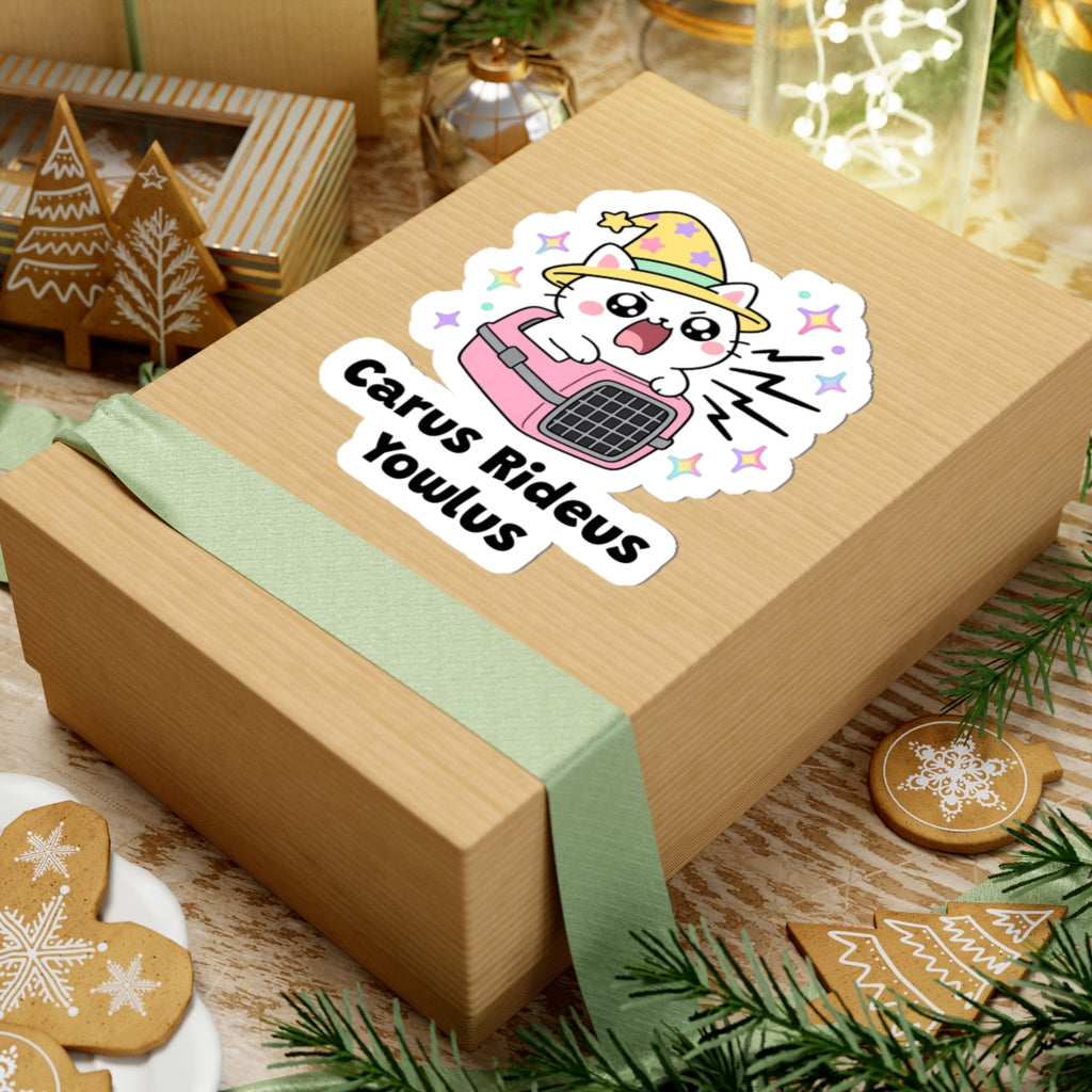 Carus Rideus Yowlus wizard cat sticker on a kraft gift box with a green ribbon and holiday cookies