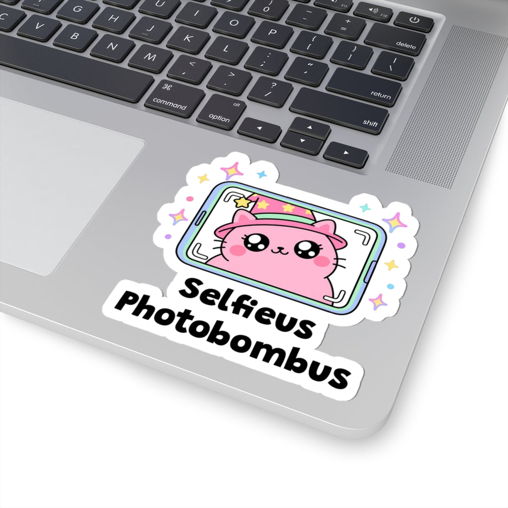 Selfieus Photobombus wizard cat sticker stuck on a silver laptop next to the keyboard