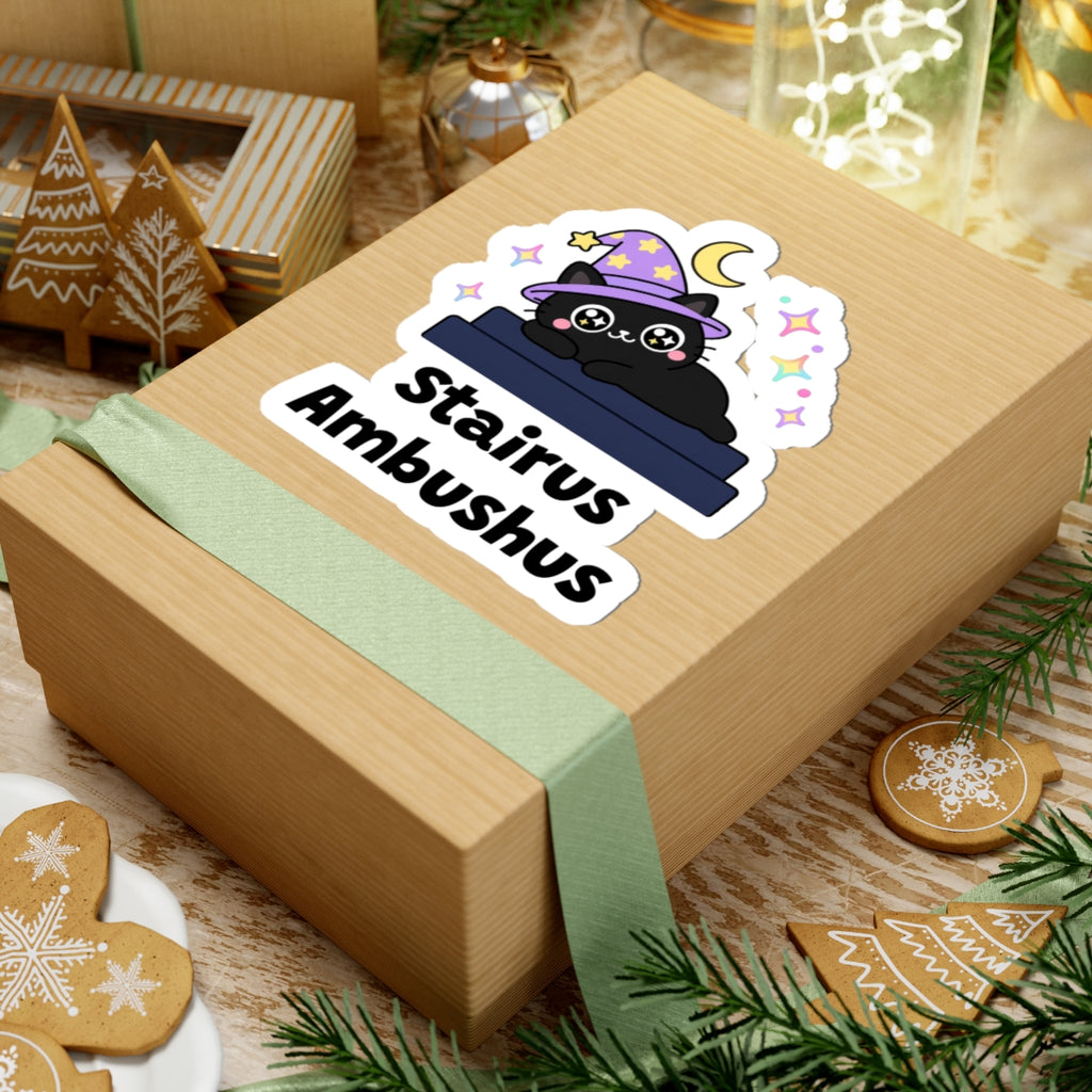 Stairus Ambushus wizard cat sticker on a kraft gift box with a green ribbon and holiday cookies