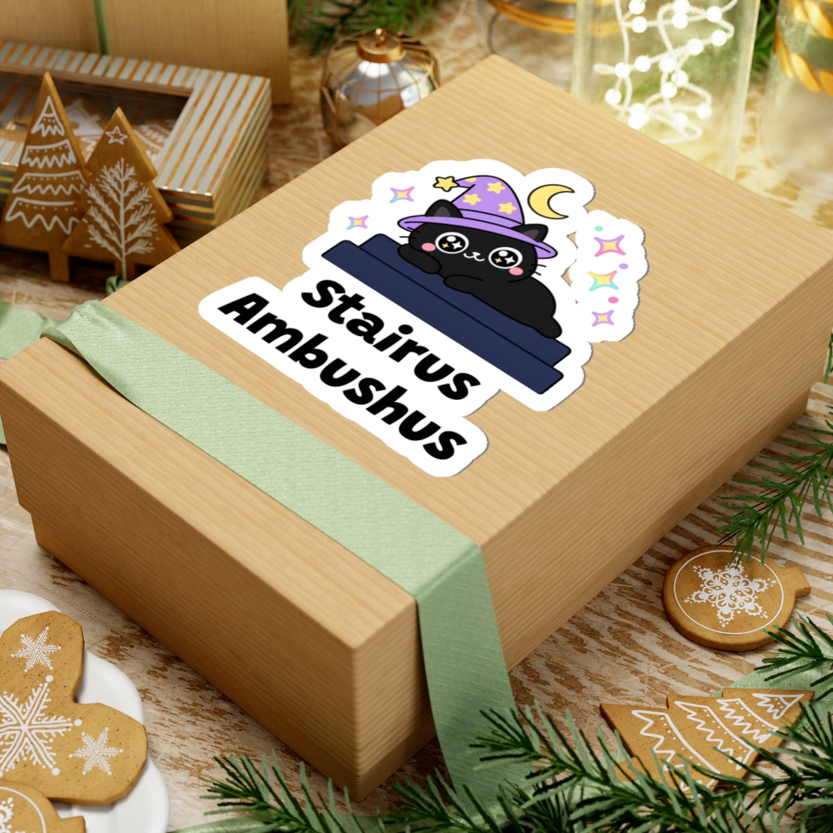 Stairus Ambushus wizard cat sticker on a kraft gift box with a green ribbon and holiday cookies