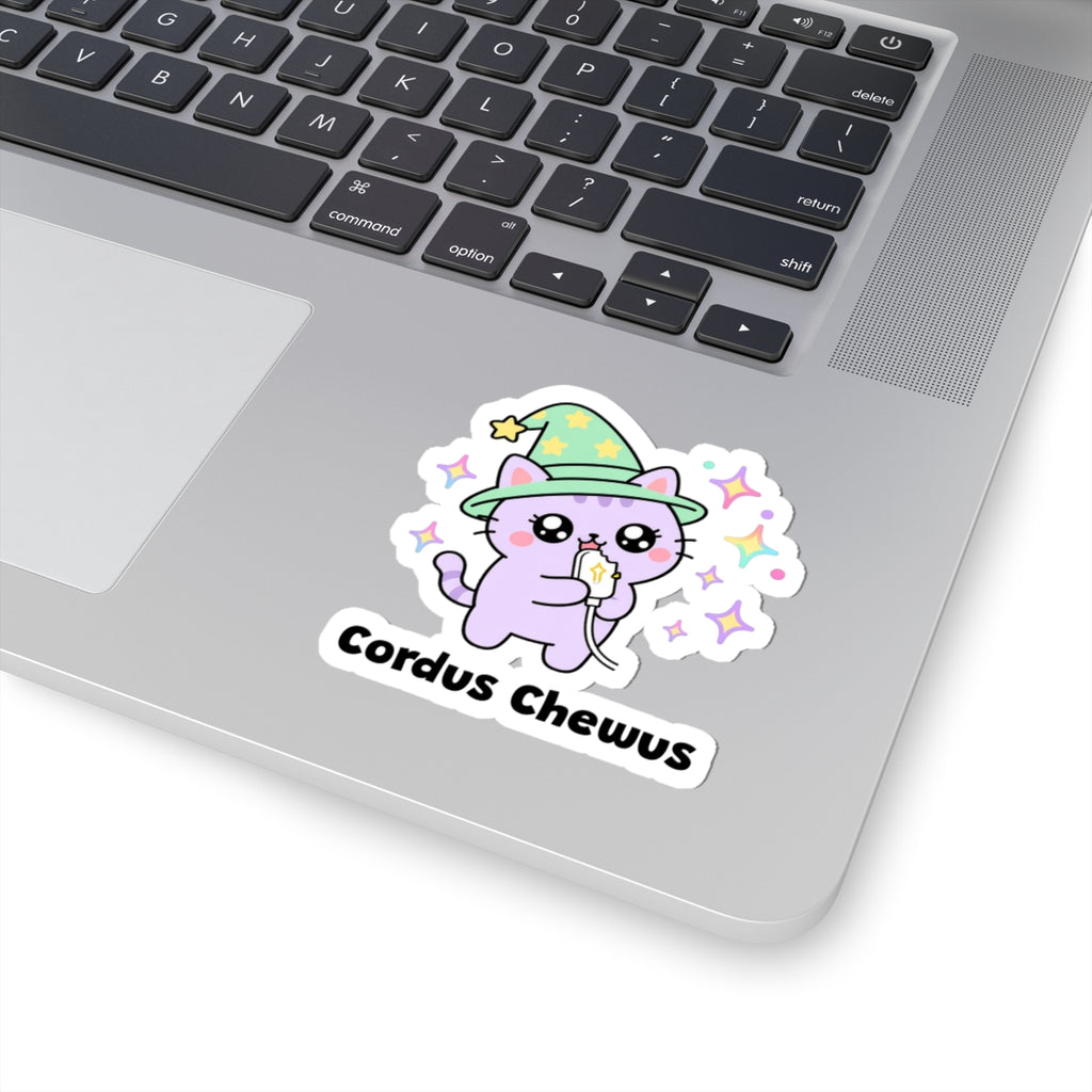 Cordus Chewus wizard cat sticker stuck on a silver laptop next to the keyboard