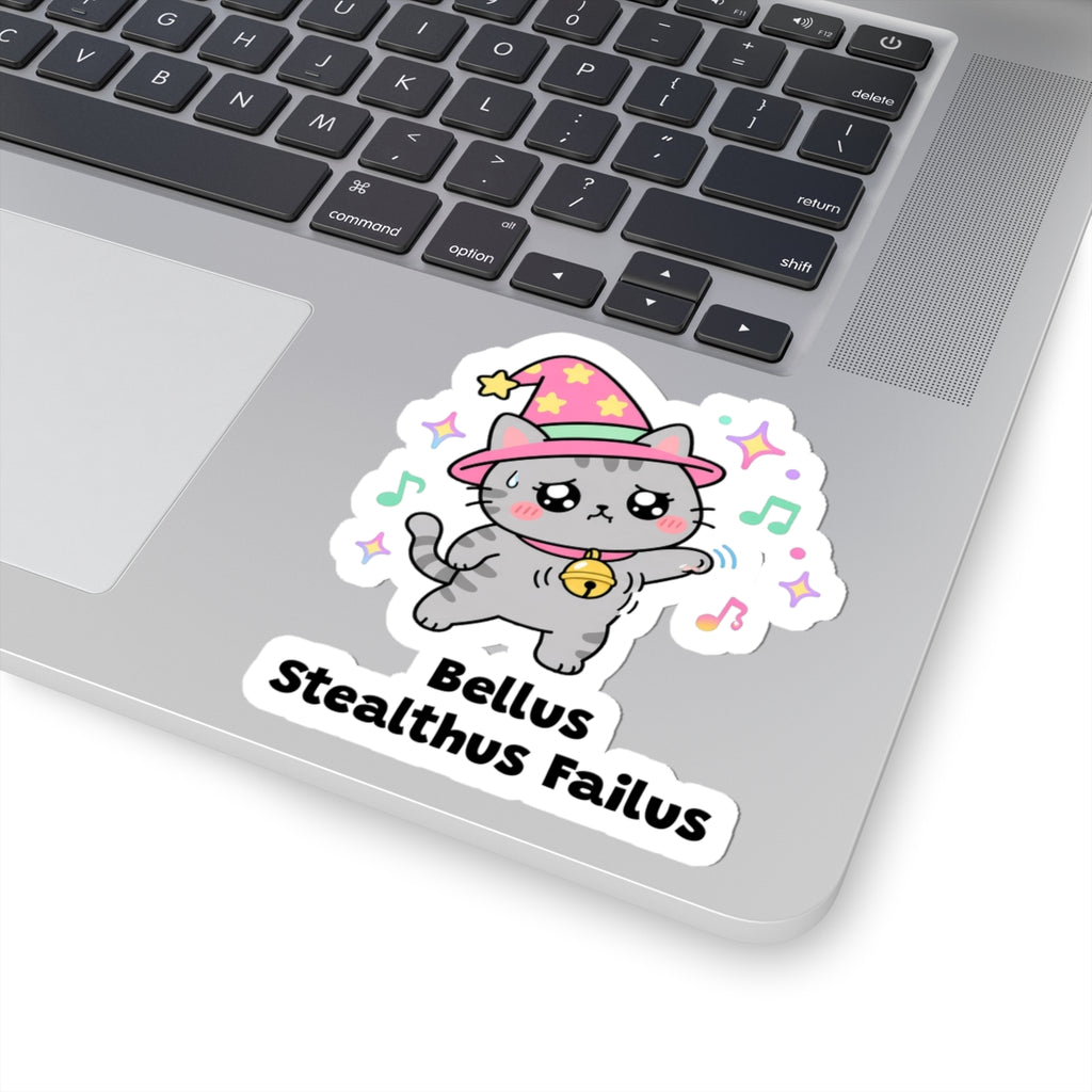 Bellus Stealthus Failus wizard cat sticker stuck on a silver laptop next to the keyboard